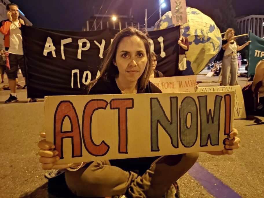 Rebel holding an Act Now sign