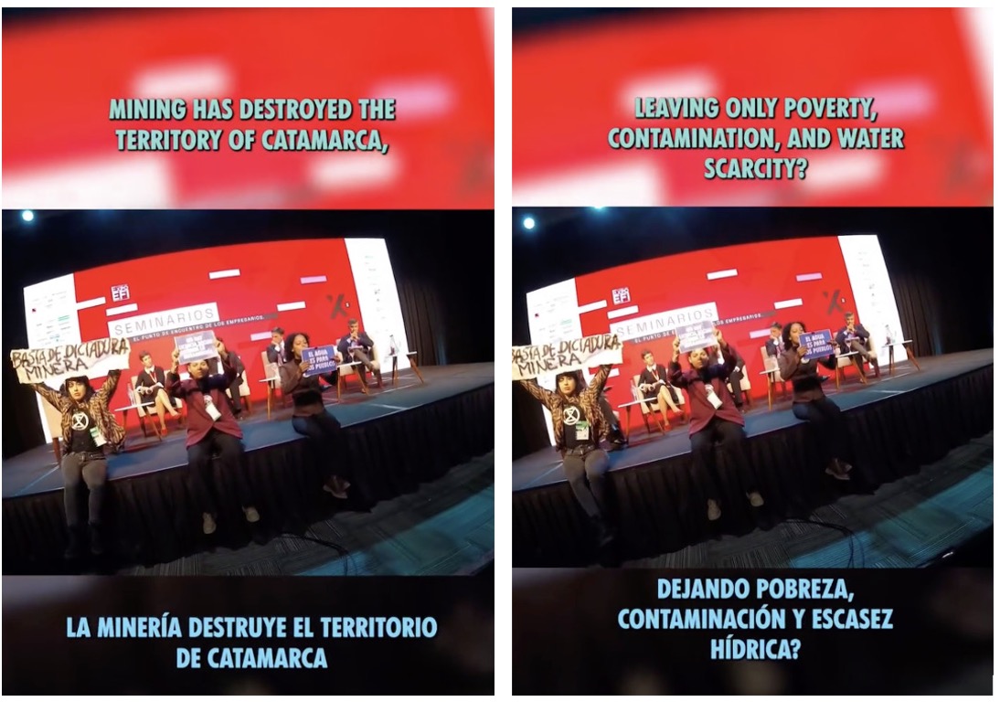 Photo of a stage panel discussion with red background screens displaying bilingual protest messages about mining's negative impact on Catamarca.